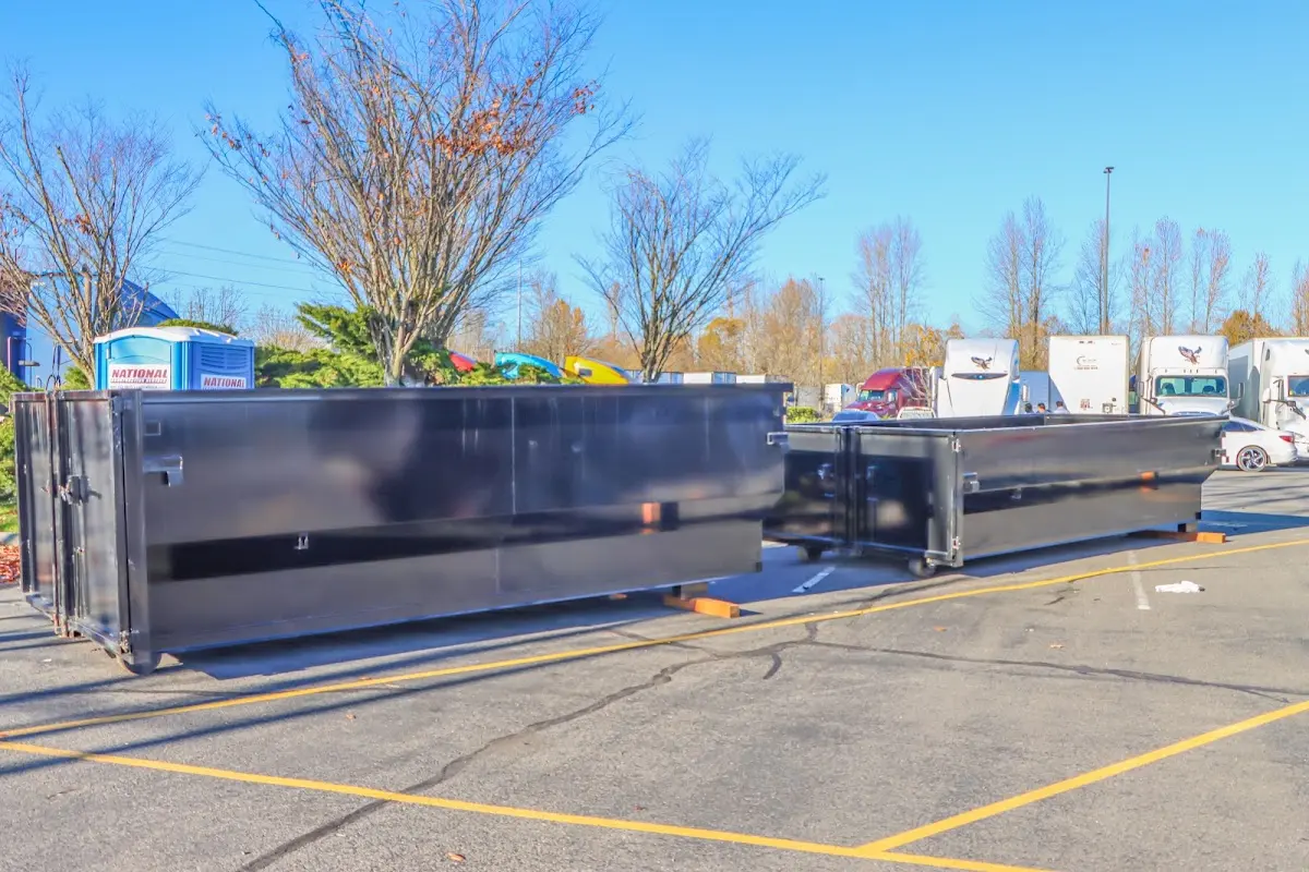 Professional dumpster rental service with roll-off container on residential driveway in Melissa